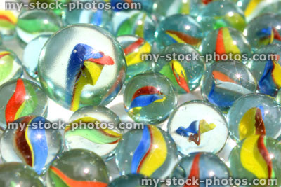Stock image of large marble with smaller marbles, standing out from the crowd
