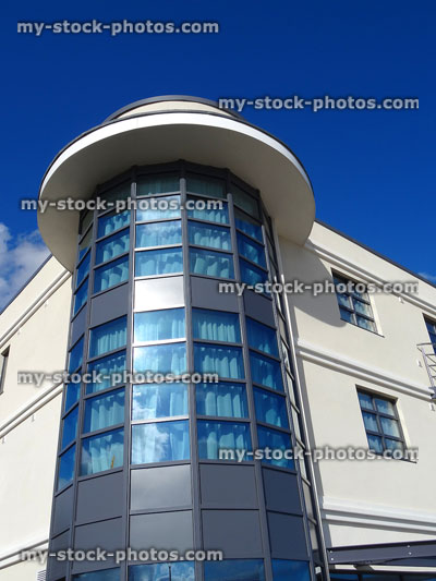 Stock image of glass tower on corner of white public building