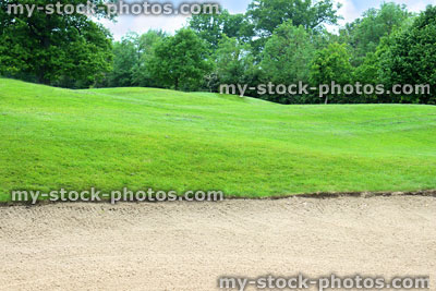 Stock image of freshly raked sandy bunker trap at golf course, golfing hazard
