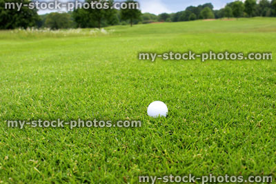 Stock image of golf ball on driving range at golf course