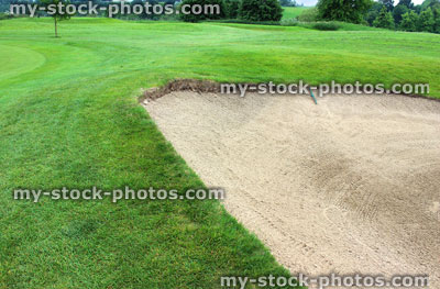 Stock image of freshly raked sandy bunker trap at golf course, golfing hazard
