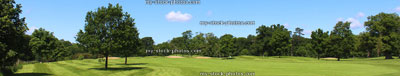 Stock image of golf course, bunkers, trees, blue sky, wide panorama