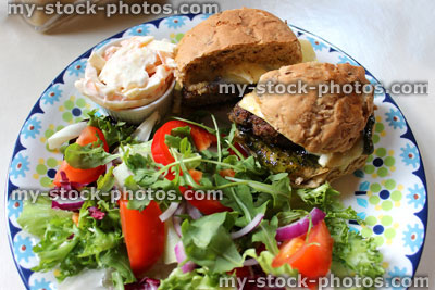 Stock image of homemade gourmet lamb burger, brie cheese, jelly mint sauce, salad