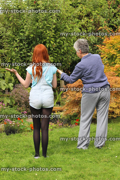 Stock image of young girl exercising in garden, grandmother / granddaughter, fitness sport / keep fit