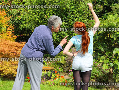 Stock image of young girl exercising in garden, grandmother / granddaughter, fitness sport / keep fit
