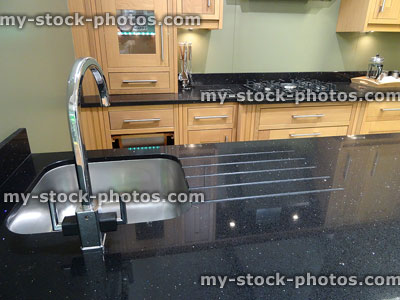 Stock image of kitchen with granite worktop / countertop surface, sink draining-board