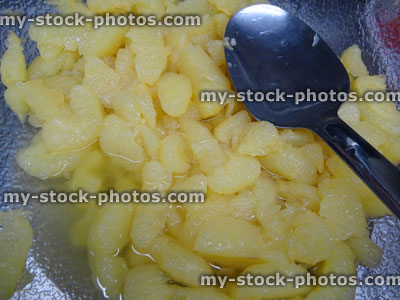 Stock image of glass bowl filled with grapefruit segments / sugar syrup, breakfast fruit