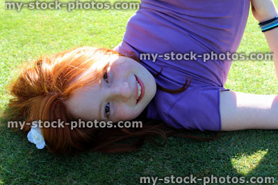 Stock image of girl exercising and stretching on a manicured lawn (close up)