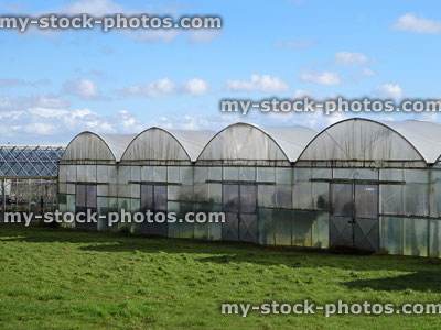 Stock image of commercial polytunnels / plastic greenhouses at garden centre nursery