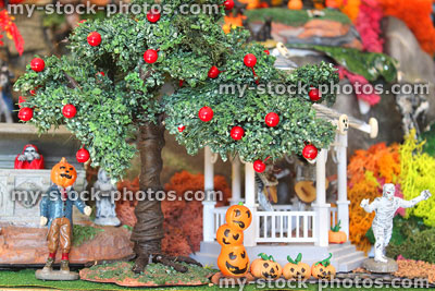 Stock image of model Halloween village with apple tree, pumpkins, monsters