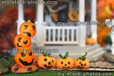 Stock image of miniature pumpkin faces / Jack-O-lanterns in model Halloween village