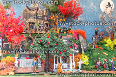 Stock image of model Halloween village diorama with red autumn trees