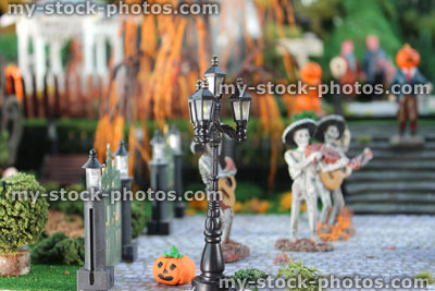 Stock image of model Halloween spooky town / village, miniature people, pumpkin head, skeleton Mariachi band, lamp
