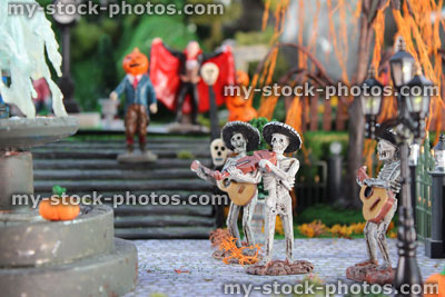 Stock image of model Halloween spooky town / village, miniature people, Dracula, pumpkin head, skeleton Mariachi band