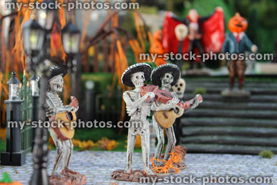 Stock image of model Halloween spooky town / village, miniature people, Dracula, pumpkin head, skeleton Mariachi band