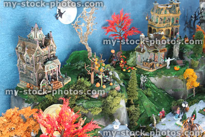 Stock image of model Halloween spooky town, miniature people, haunted house, flying witch, broomstick, full moon