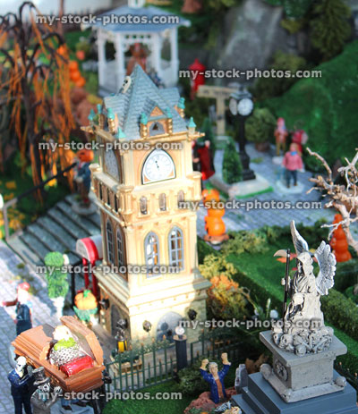 Stock image of model Halloween spooky town / village, miniature Grim Reaper statue / Angel of Death, clock tower