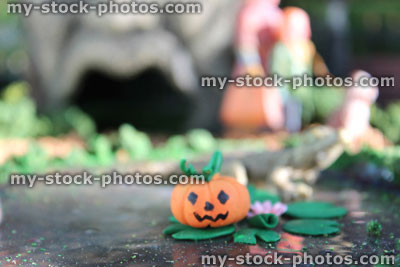 Stock image of model pond, Fimo clay water lilies / lily pads, miniature pumpkin head