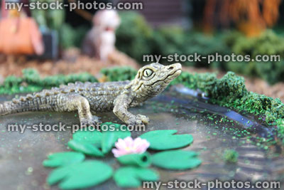 Stock image of model pond, Fimo clay water lilies / lily pads, miniature toy crocodile
