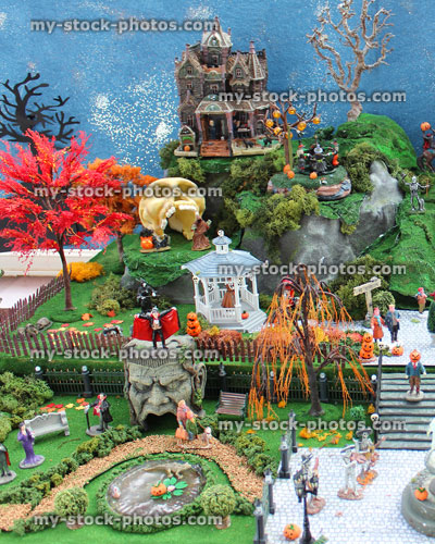 Stock image of model Halloween town / village, miniature houses, skeletons, pumpkins, skulls, clock tower, full moon