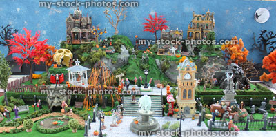 Stock image of model Halloween town / village, miniature houses, skeletons, pumpkins, skulls, clock tower, full moon