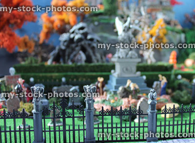 Stock image of model Halloween spooky town, miniatures, graveyard, cemetery, gravestones, zombies, iron railings, gargoyles