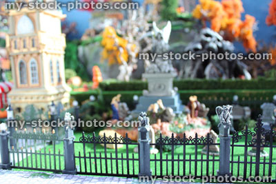 Stock image of model Halloween spooky town, miniatures, graveyard, cemetery, gravestones, zombies, iron railings, gargoyles
