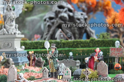 Stock image of model Halloween spooky town / village, miniature graveyard cemetery, grave digger, Dracula vampire, gravestones, zombies