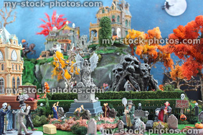 Stock image of model Halloween spooky town, miniature graveyard cemetery, grave digger, Dracula vampire, gravestones, zombies, Grim Reaper
