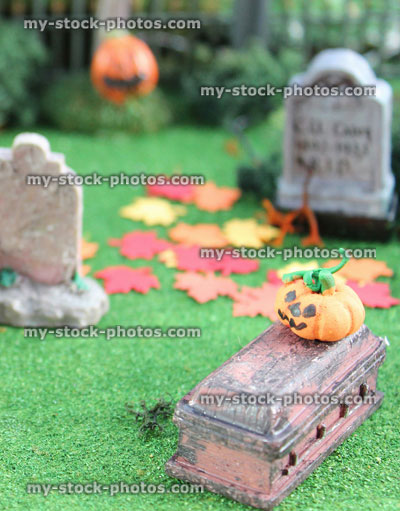 Stock image of model Halloween spooky town / village, miniature graveyard cemetery, pumpkin, coffin, gravestone
