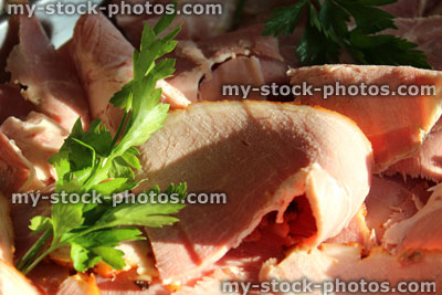 Stock image of platter of sliced gammon ham on plate, buffet party food
