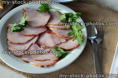 Stock image of platter of sliced gammon ham on plate, buffet party food