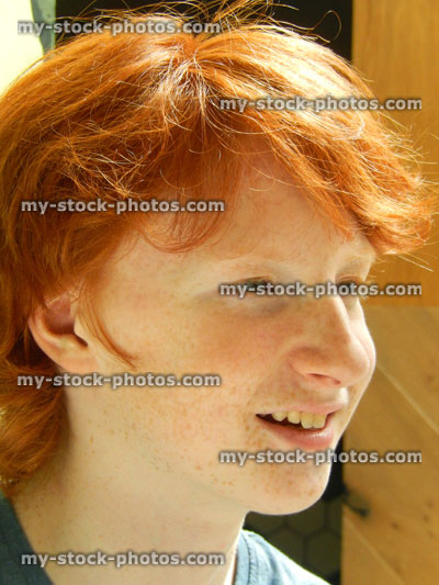 Stock image of portrait / profile of handsome teenage boy with red hair