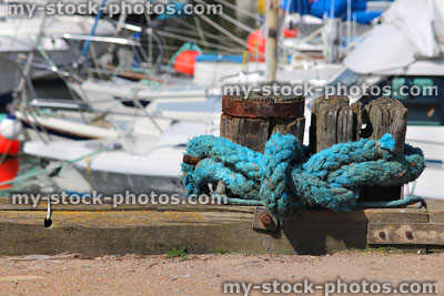 Stock image of blue rope knot at harbour marina with yachts boats
