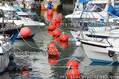 Stock image of marina with pleasure boats, yachts and floating red buoys