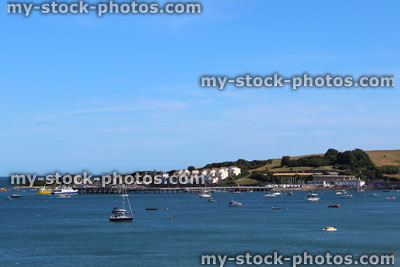 Stock image of harbour at seaside, with cliffs, boats, yachts, beach