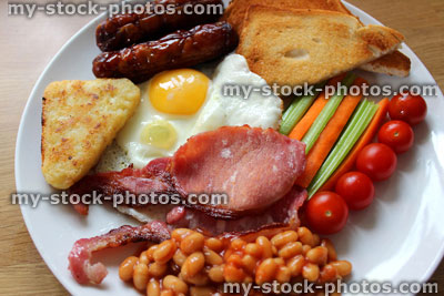 Stock image of low calorie, full English fried breakfast with healthy elements, raw vegetables, baked beans