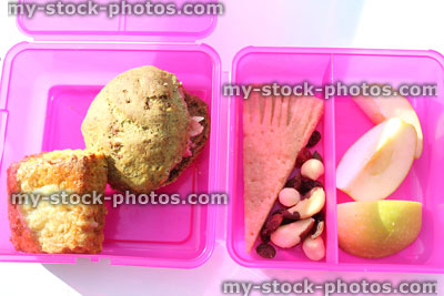 Stock image of girl's healthy eating pink lunchbox with wholemeal sandwich