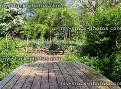 Stock image of ornamental vegetable garden / herb garden with willow weaving, decking bridge