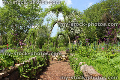 Stock image of ornamental vegetable garden / herb garden with woven willow arches