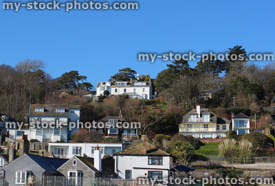 Stock image of individual detached houses on steep hillside, sea views