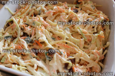 Stock image of homemade coleslaw, shredded white cabbage, grated carrot, sliced onion, mayonnaise