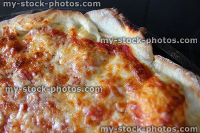 Stock image of homemade cheese and tomato pizza crust, margarita pizza