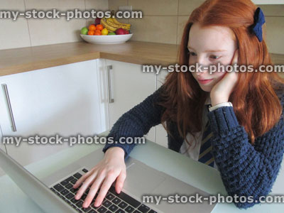 Stock image of girl sat in front of MacBook laptop