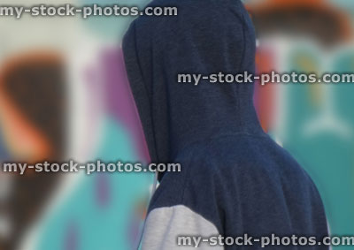 Stock image of boy wearing hoodie against colourful blurred background
