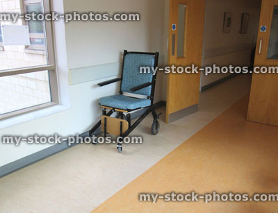 Stock image of NHS Hospital Corridor, cushioned wheelchair seat with wheels
