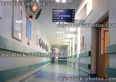 Stock image of hospital corridor with hanging signs / directions to wards