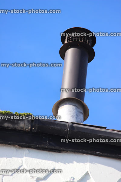 Stock image of black metal chimney pot with mesh grille, stop birds