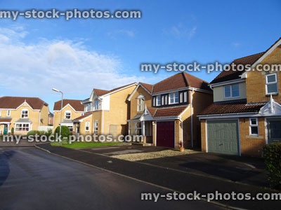 Stock image of modern housing estate with detached brick executive houses
