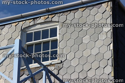Stock image of seaside house, hexagon shaped slate tiles on exterior wall